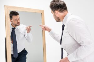 An image illustrating the relationship between drug use and narcissism, showing a person with a mirror.